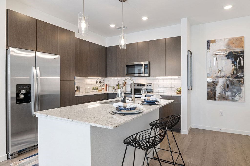 a kitchen with a counter and two bar stools