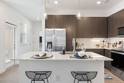 a kitchen with a large island with plates on it