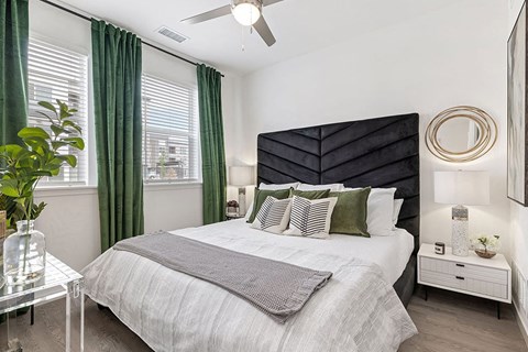 a bedroom with a bed and a ceiling fan