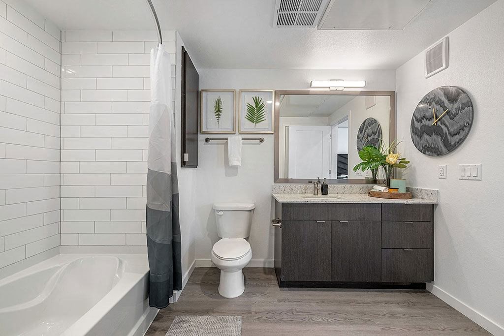 a bathroom with a toilet sink and a bath tub