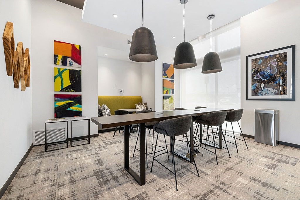 a dining room with a long table and chairs
