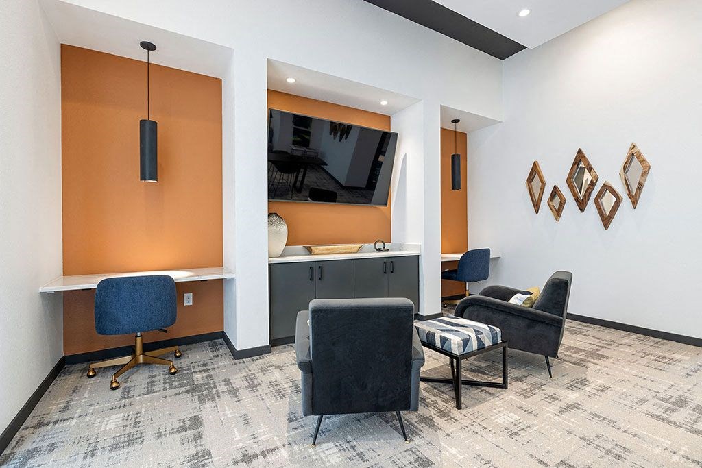 a waiting room with chairs and a television in a hospital