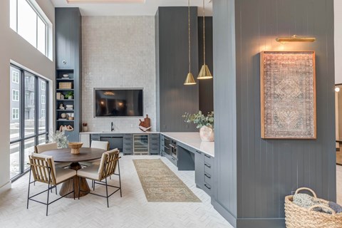 A modern kitchen with a dining table and chairs.