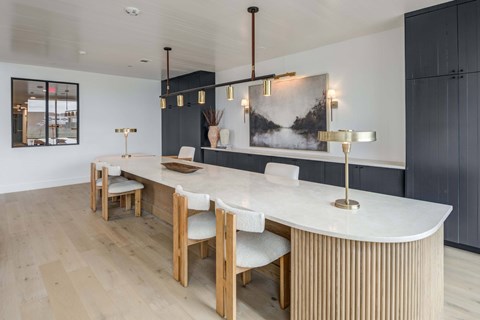 A modern dining room with a white table and chairs. at The Grayson, Fort Worth, TX