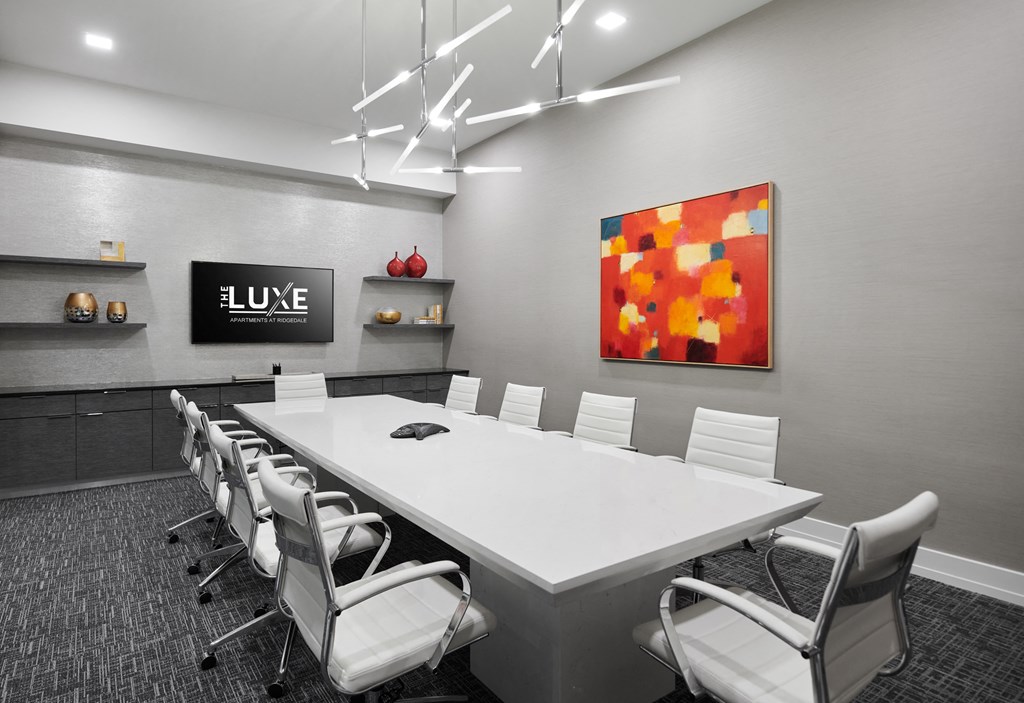 a conference room with a white table and chairs