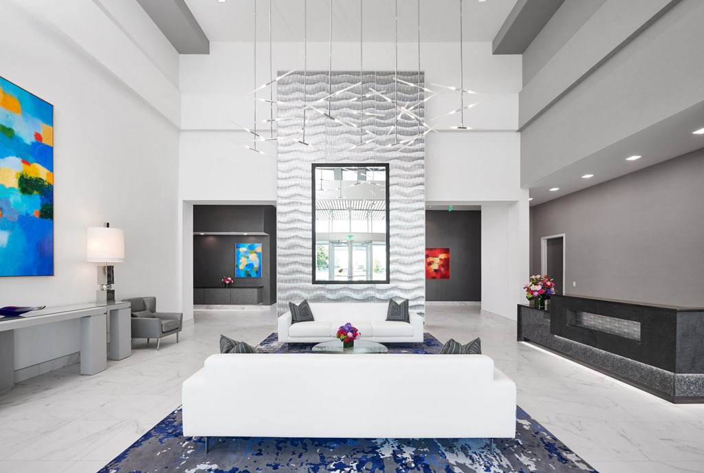 a living room with a white couch and a chandelier