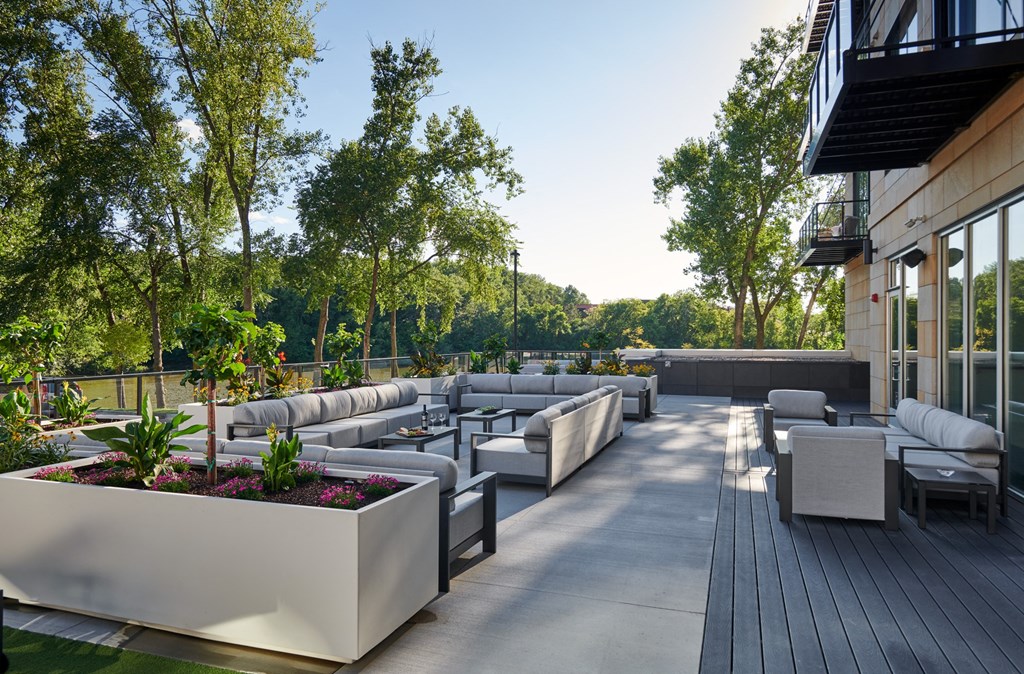 a lounge area with couches and tables on a patio