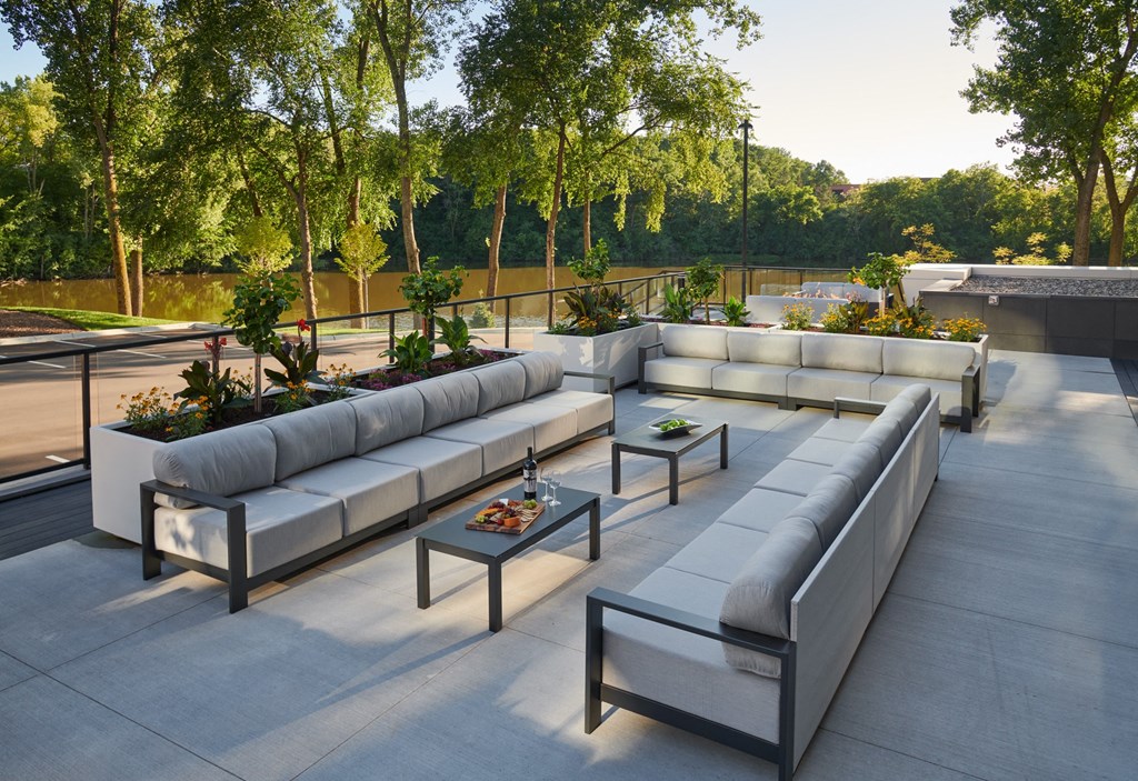 a seating area with couches and tables on a patio