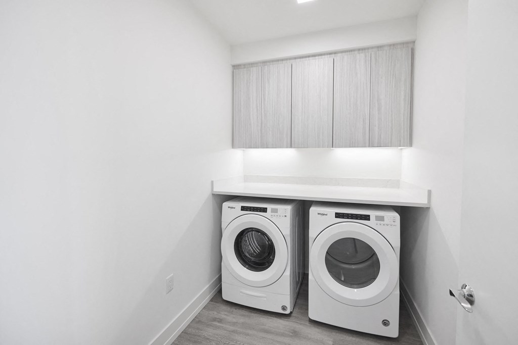 a washer and dryer in a laundry room with white walls