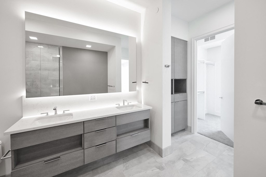 a large bathroom with two sinks and a large mirror