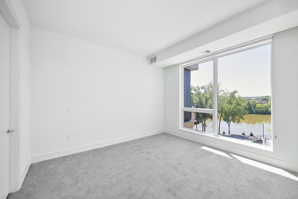 an empty living room with a large window