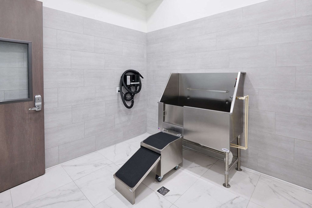 a handicapped accessible urinal in a bathroom with a privacy screen