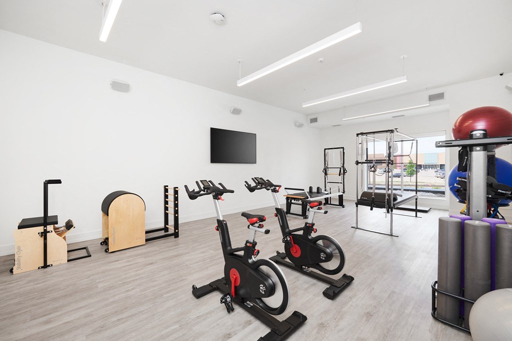 a group of exercise bikes in a gym
