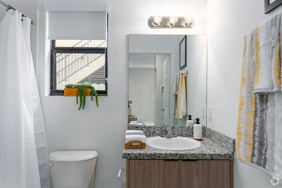 a bathroom with a sink toilet and a mirror