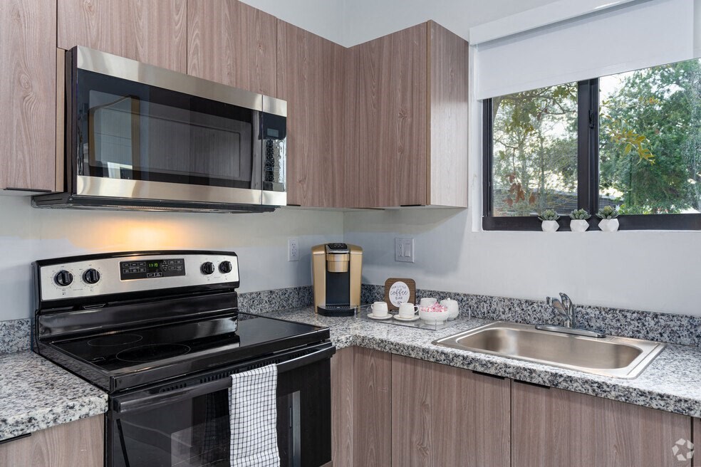 a kitchen with a stove microwave and sink