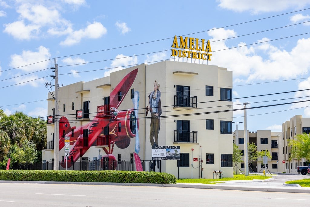 a building with a mural of a red plane on the side of it