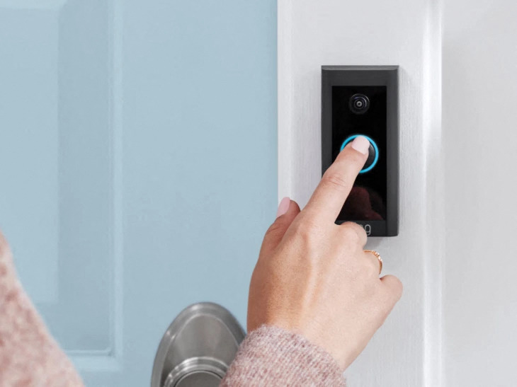 a person ringing a ring video doorbell