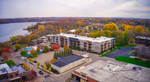 an aerial view of an apartment complex with a river in the background