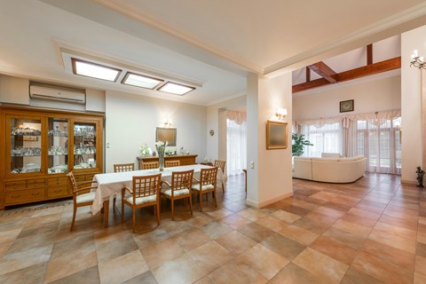 A dining room with a table set for six.