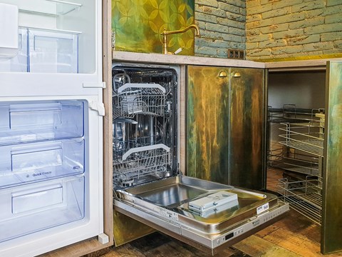A modern kitchen with a stainless steel dishwasher and a white refrigerator.