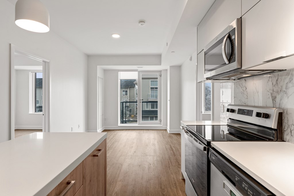 A modern kitchen with a stainless steel oven and microwave.