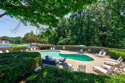 a pool with chairs and chairs around it and a swimming pool