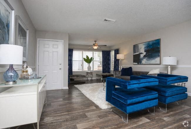 a living room with blue chairs and a white