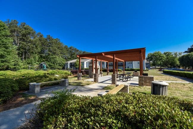 a picnic area with a pavilion in a park