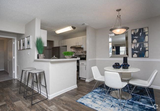 a kitchen and dining room with a table and chairs