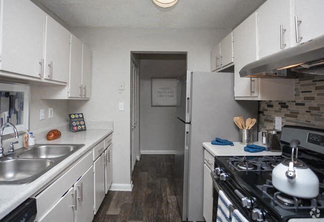 a kitchen with a stove and a refrigerator
