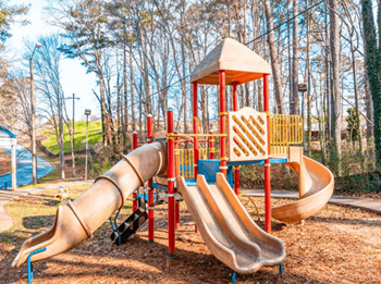 a playground with slides and a swing set