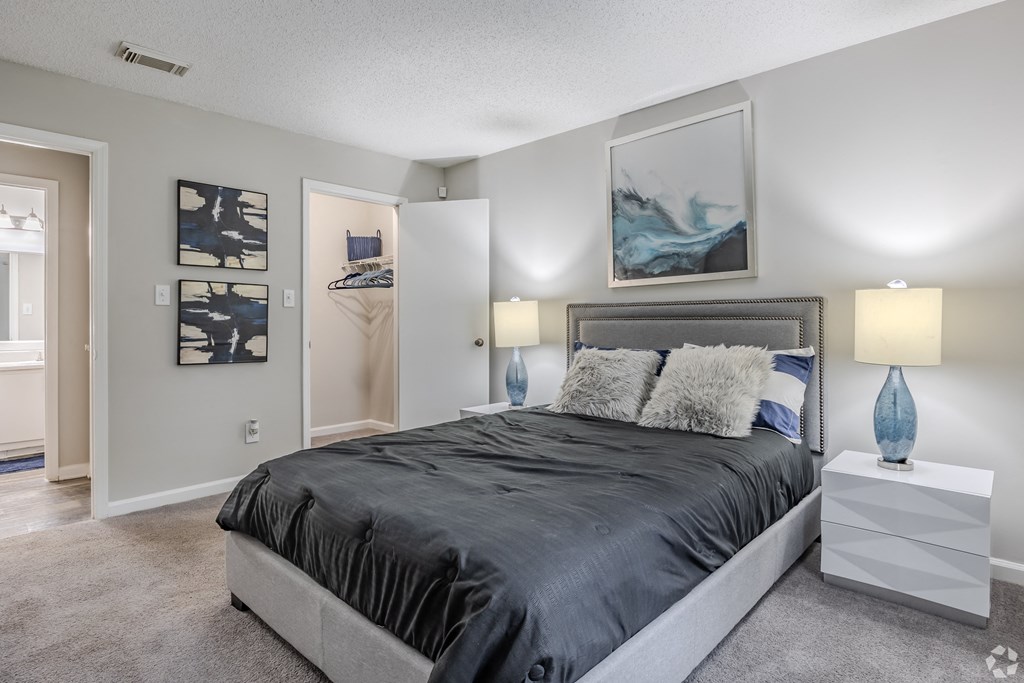 a bedroom with a large bed and a closet