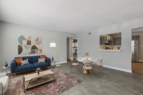 A living room with a blue couch and a coffee table.