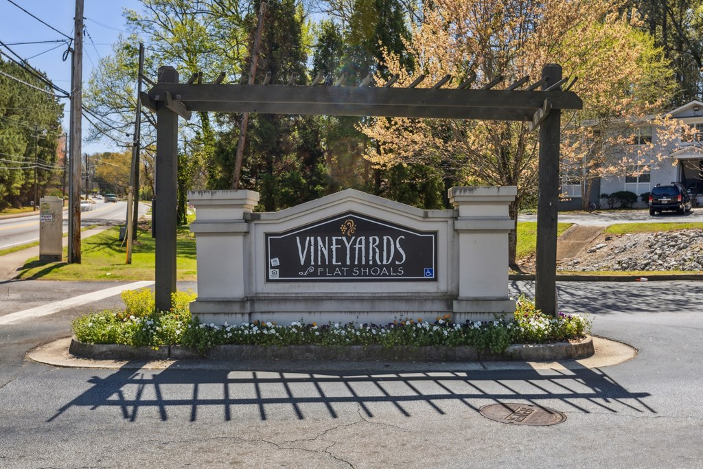 A sign for Vineyards Plate Schools is in front of a building.