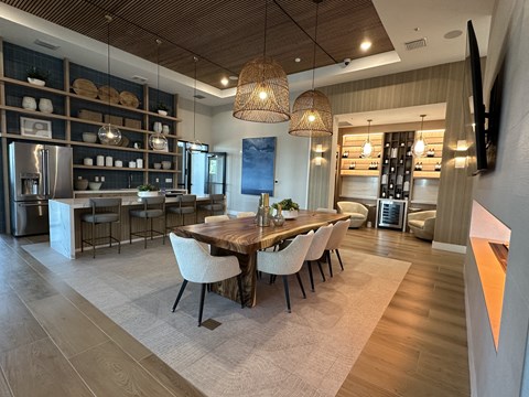 A modern kitchen with a dining table and chairs.