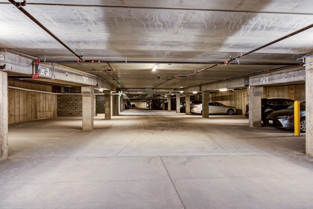 the inside of a parking garage with cars in it