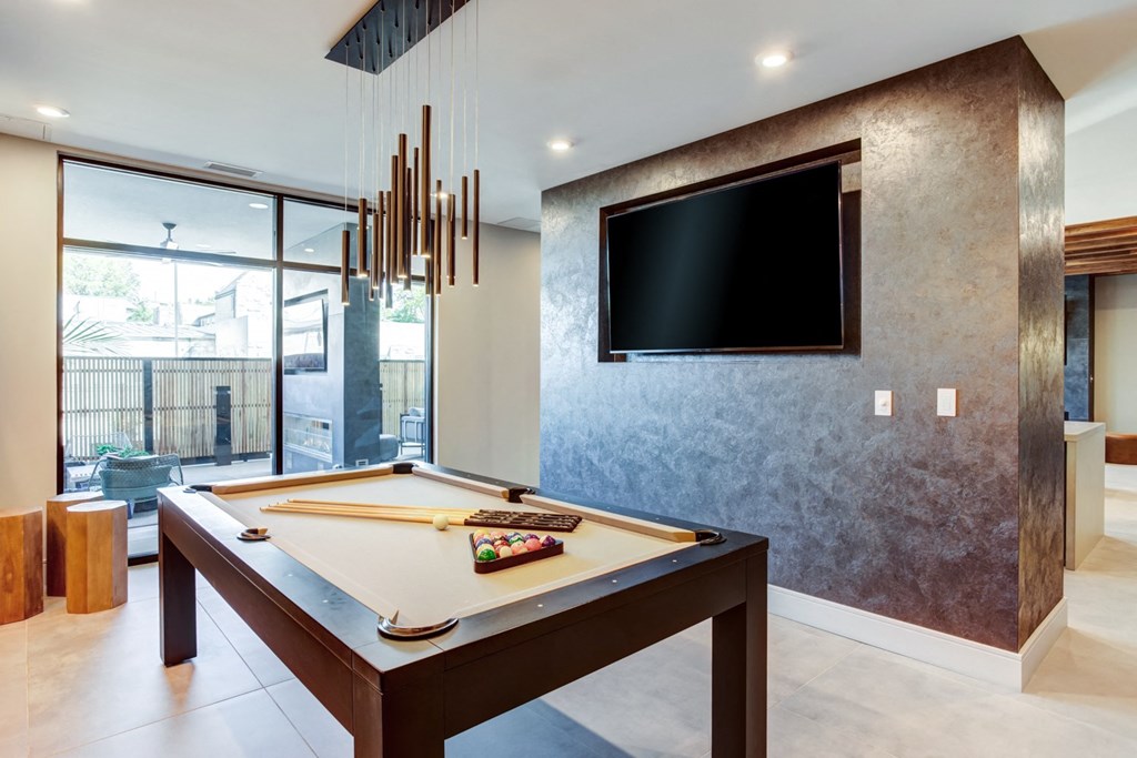 a living room with a tv on the wall and a table