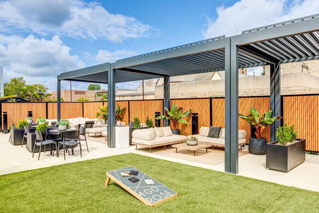 a patio with couches and chairs and a table under awning