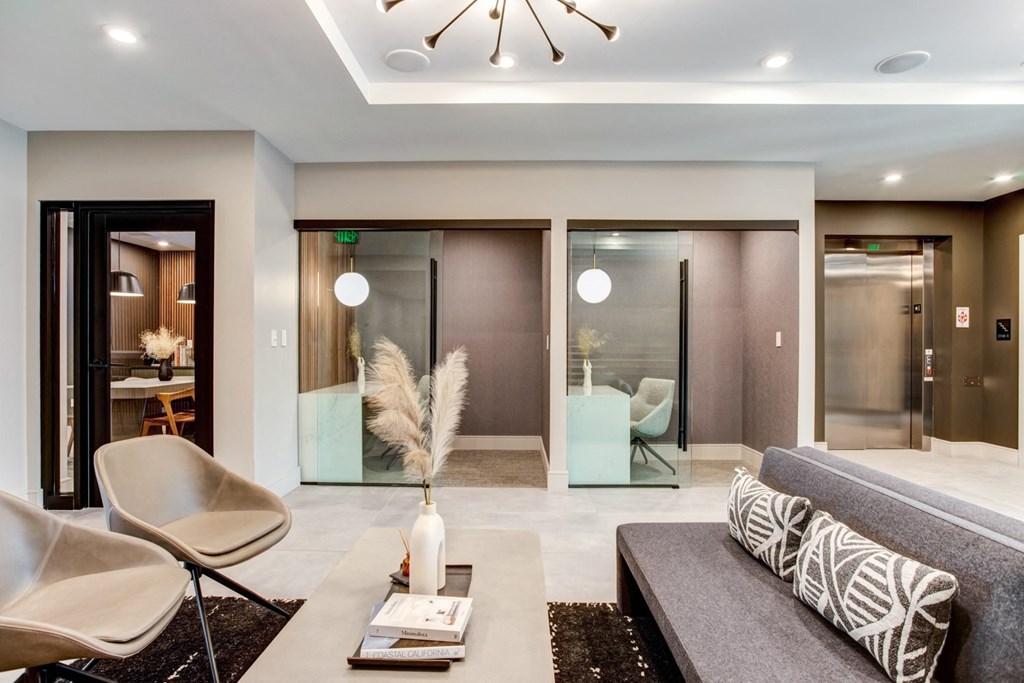 a living room with a couch and chairs and sliding glass doors