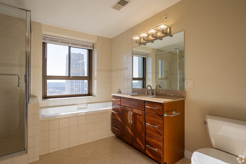 a bathroom with a sink and a toilet and a shower