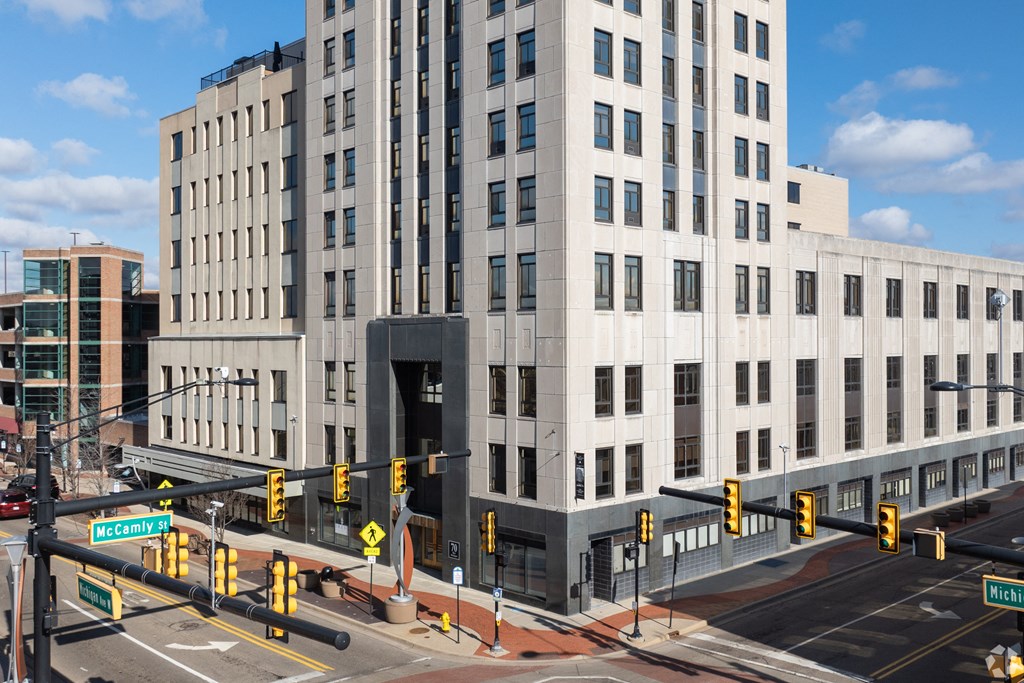 a large white building on the corner of a city street