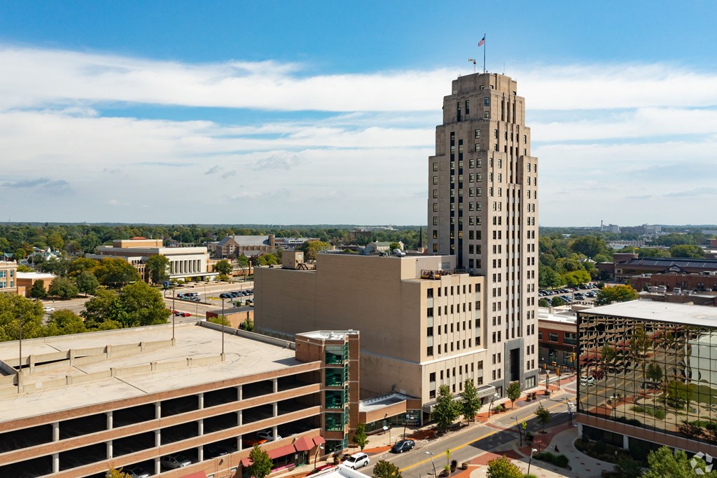 an aerial view of a tall building in a city