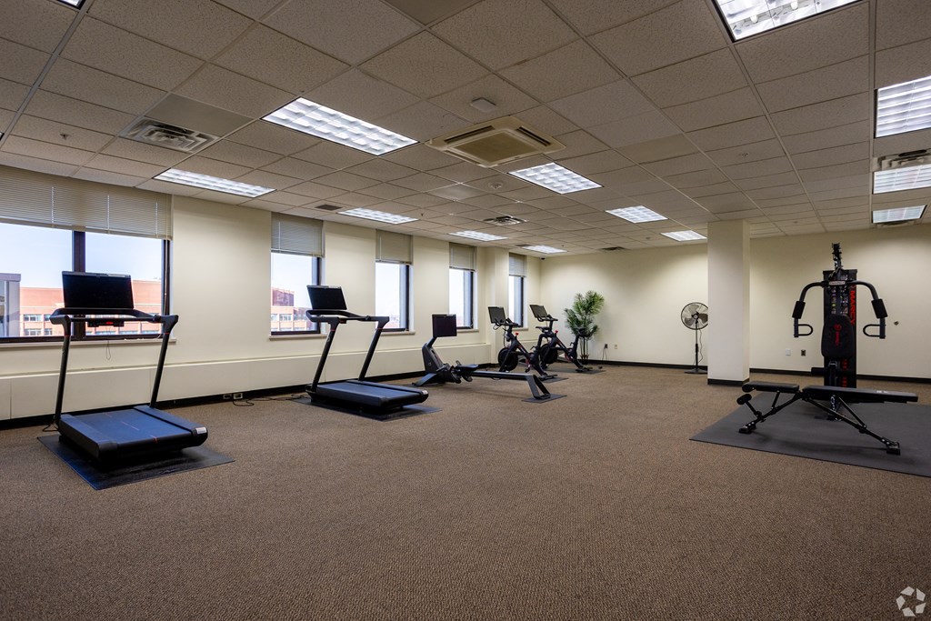 a fitness room with weights and other exercise equipment