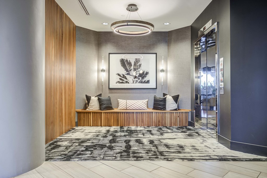 a lobby with a bench and pillows on it