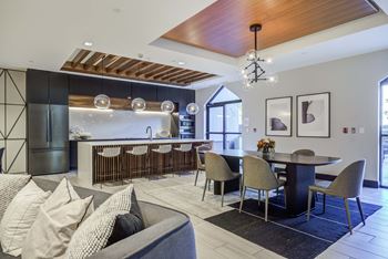 a living room with a kitchen and a dining table