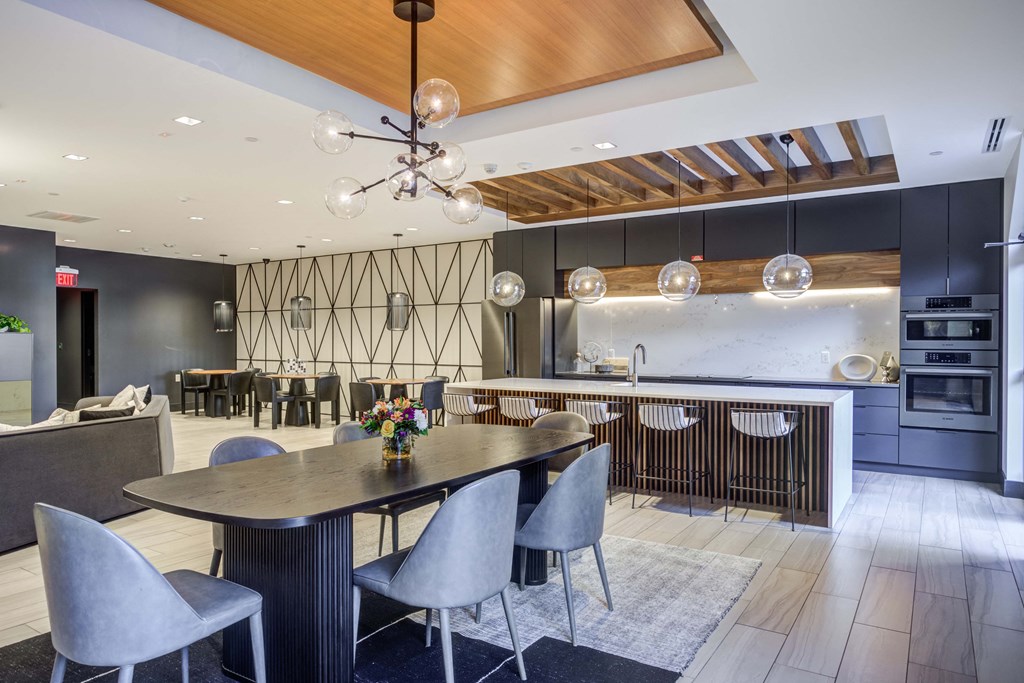 a large dining room with a table and chairs and a kitchen