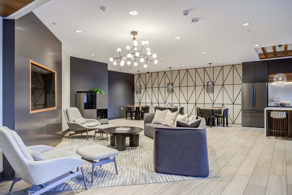 a lobby with couches chairs and tables and a chandelier
