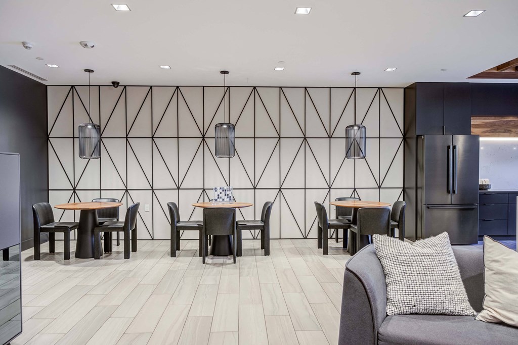 a dining room with tables and chairs and a refrigerator