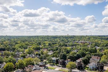 the view of a neighborhood with trees and houses from a window