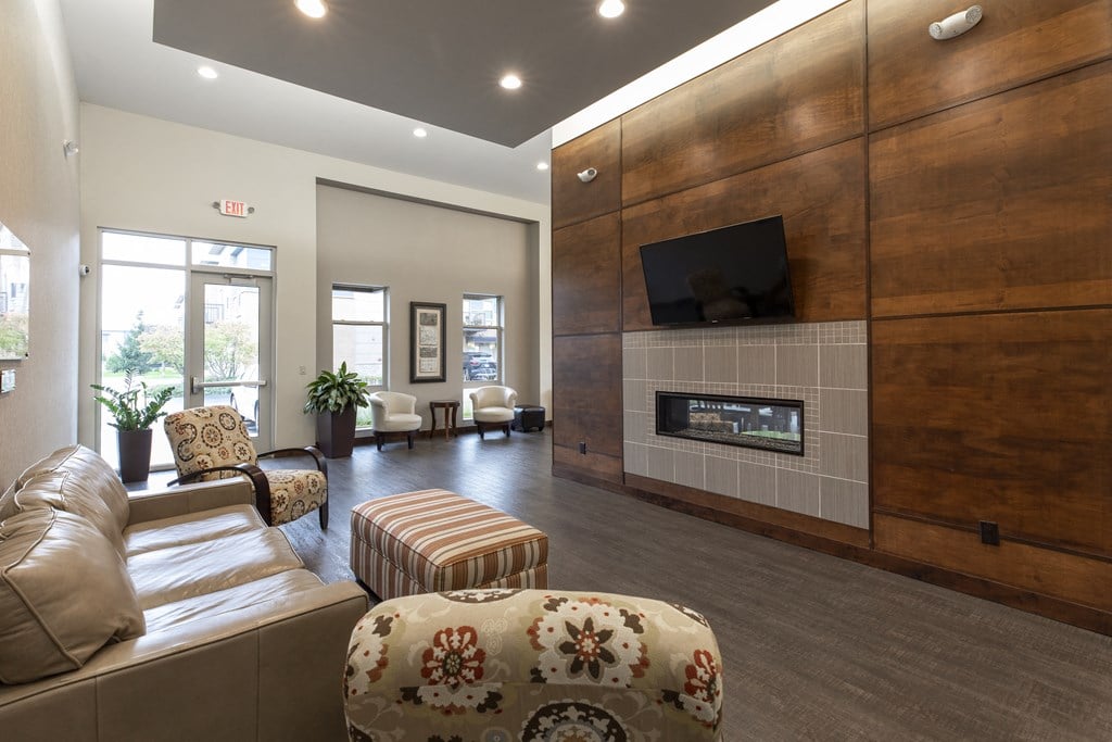 a large living room with a fireplace and a tv